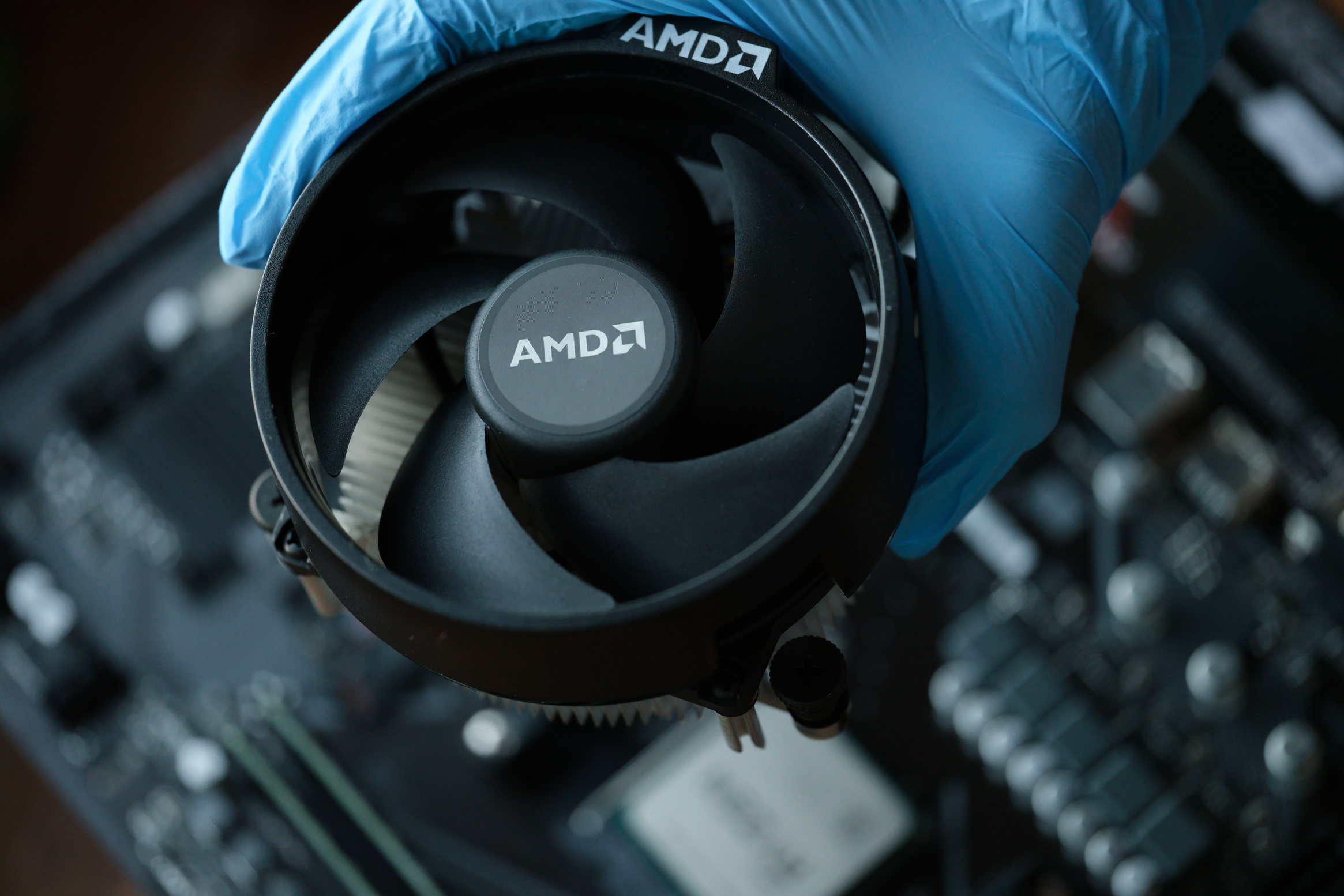 Hand in Glove Installs Cpu Fan AMD Closeup